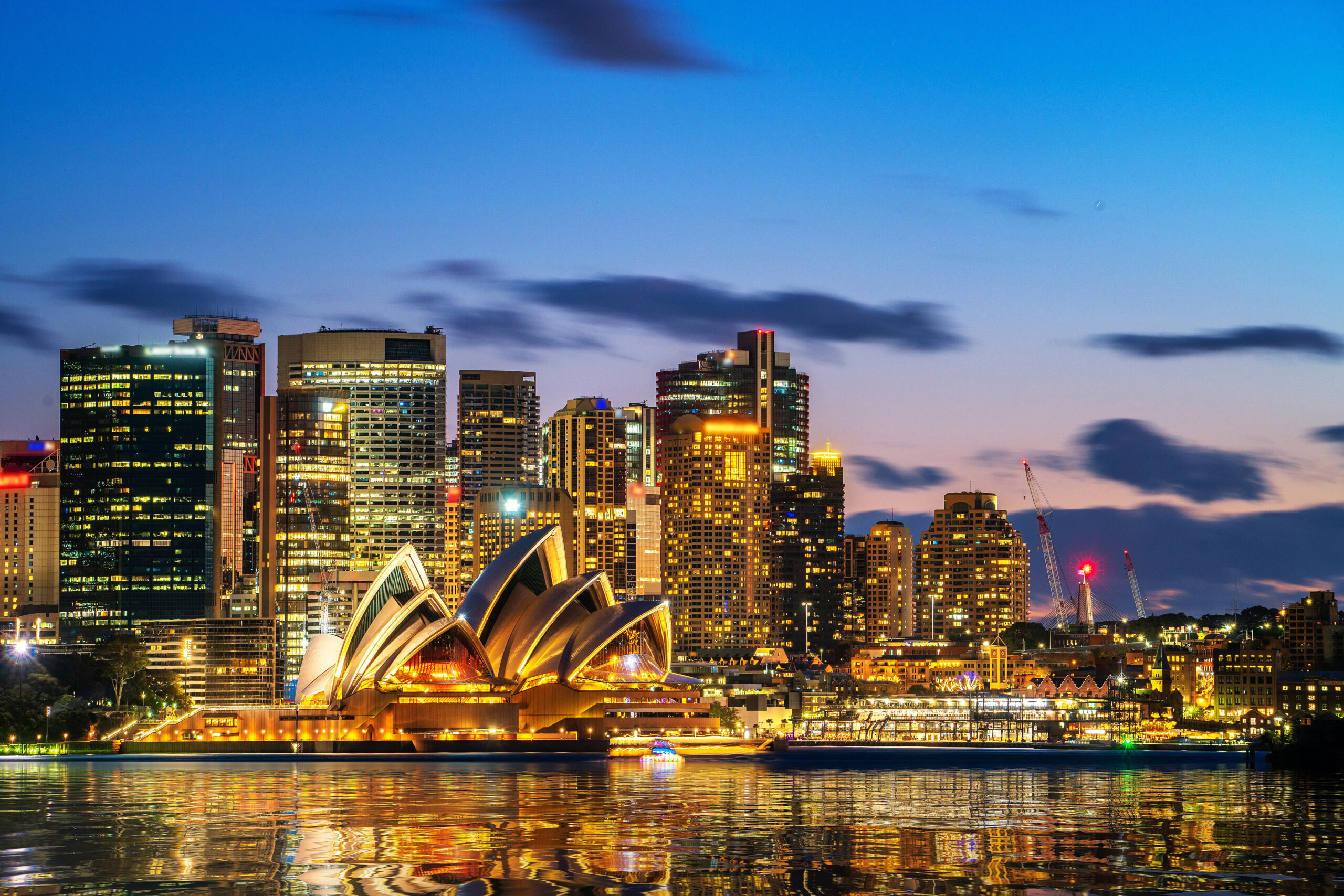 Sydney CBD from a ferry on the harbour with the city Buildings in the background at Sunset, Facility Management Sydney