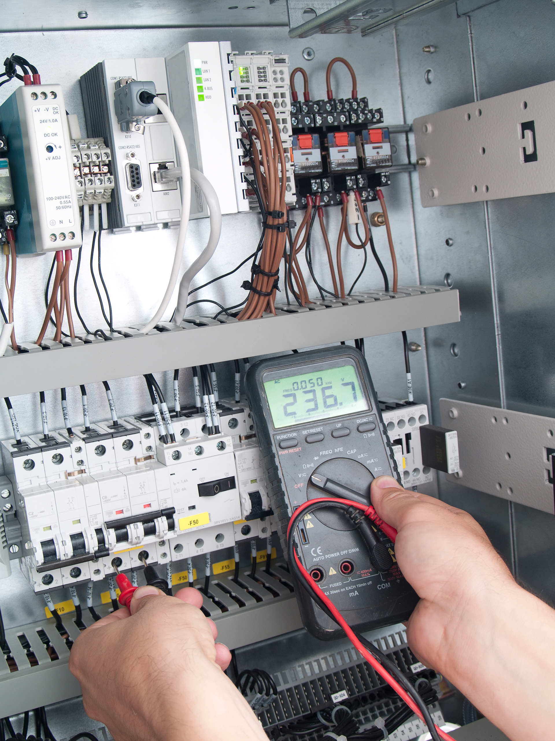 Performance Facility Management Employee working on fault finding a panel in a commercial property building in South Melbourne