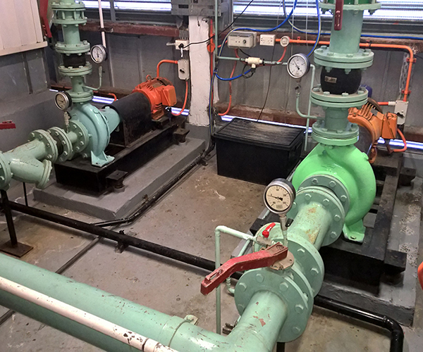 Commercial Building maintenance  -  HVAC Mechanical services in the plant room of a Chatwood building showing condenser water pumps one and two both in operation and controlled by the building automation system, Sydney