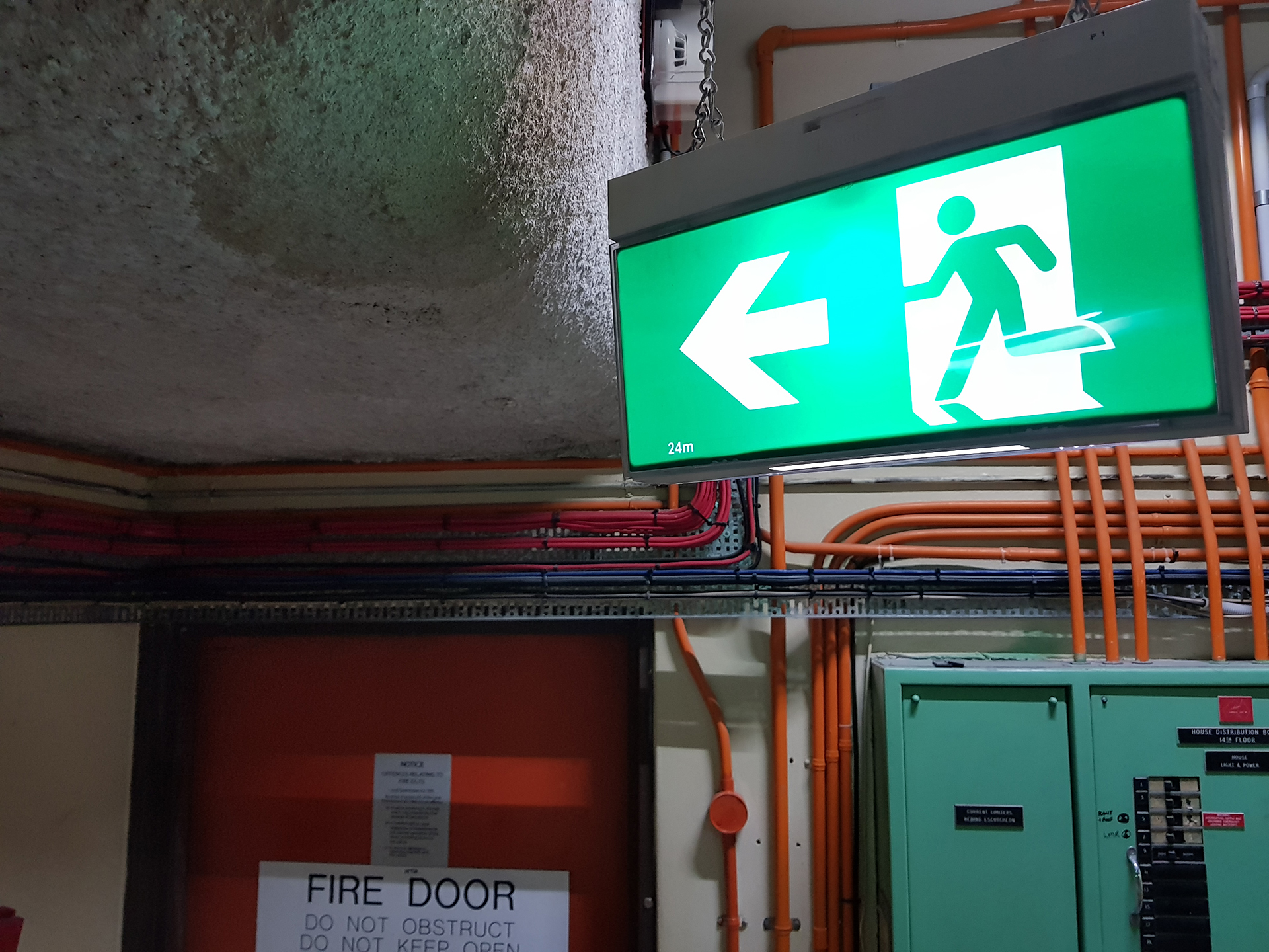 Unsuprvised Building - Emergecny Lighting - Runningman Exit Light in Roof Top Plant room in Melbourne Syburb Commercial Property building