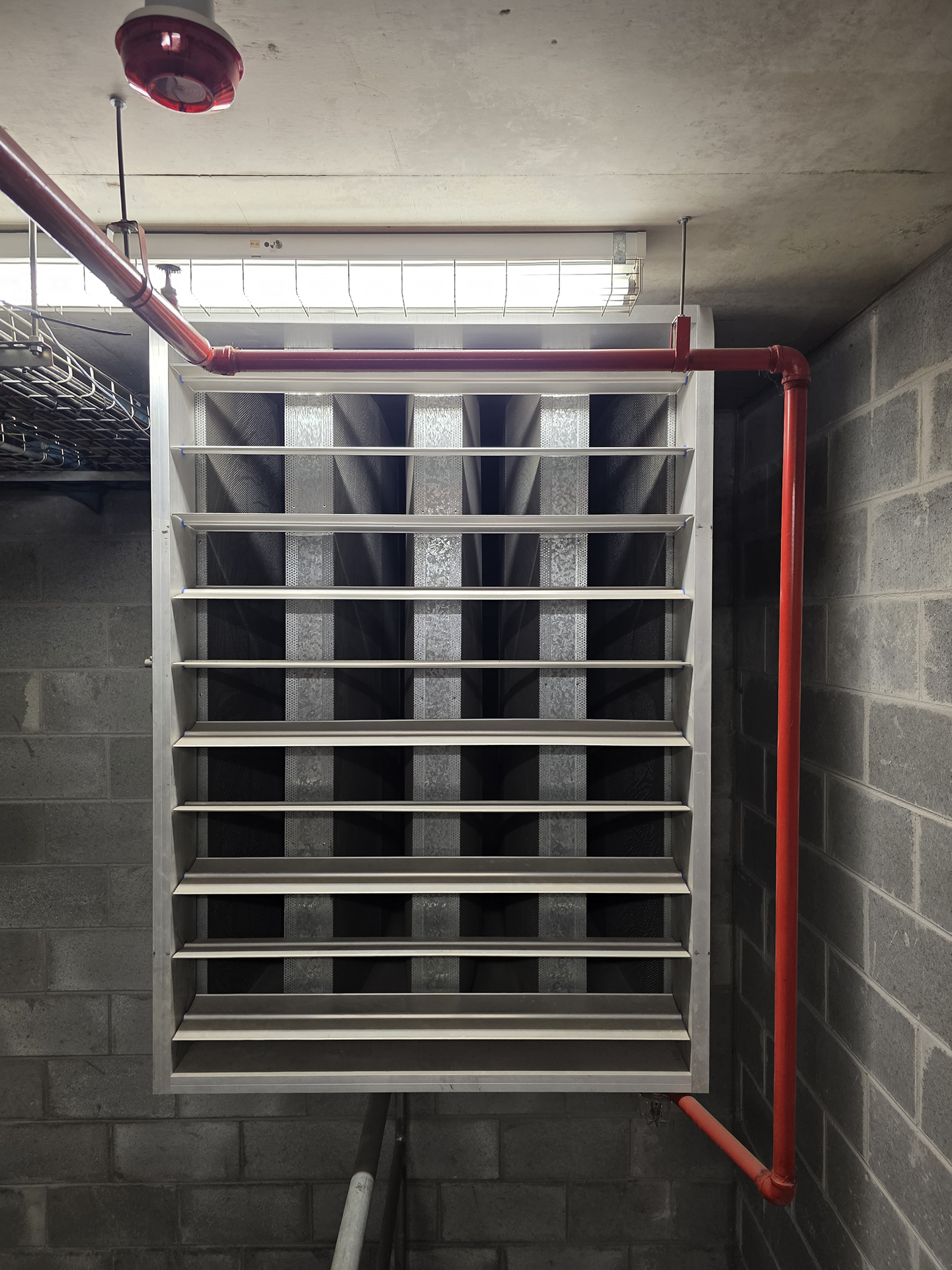Performance Facility Management Employee working on fault finding a panel in a commercial property building in South Melbourne