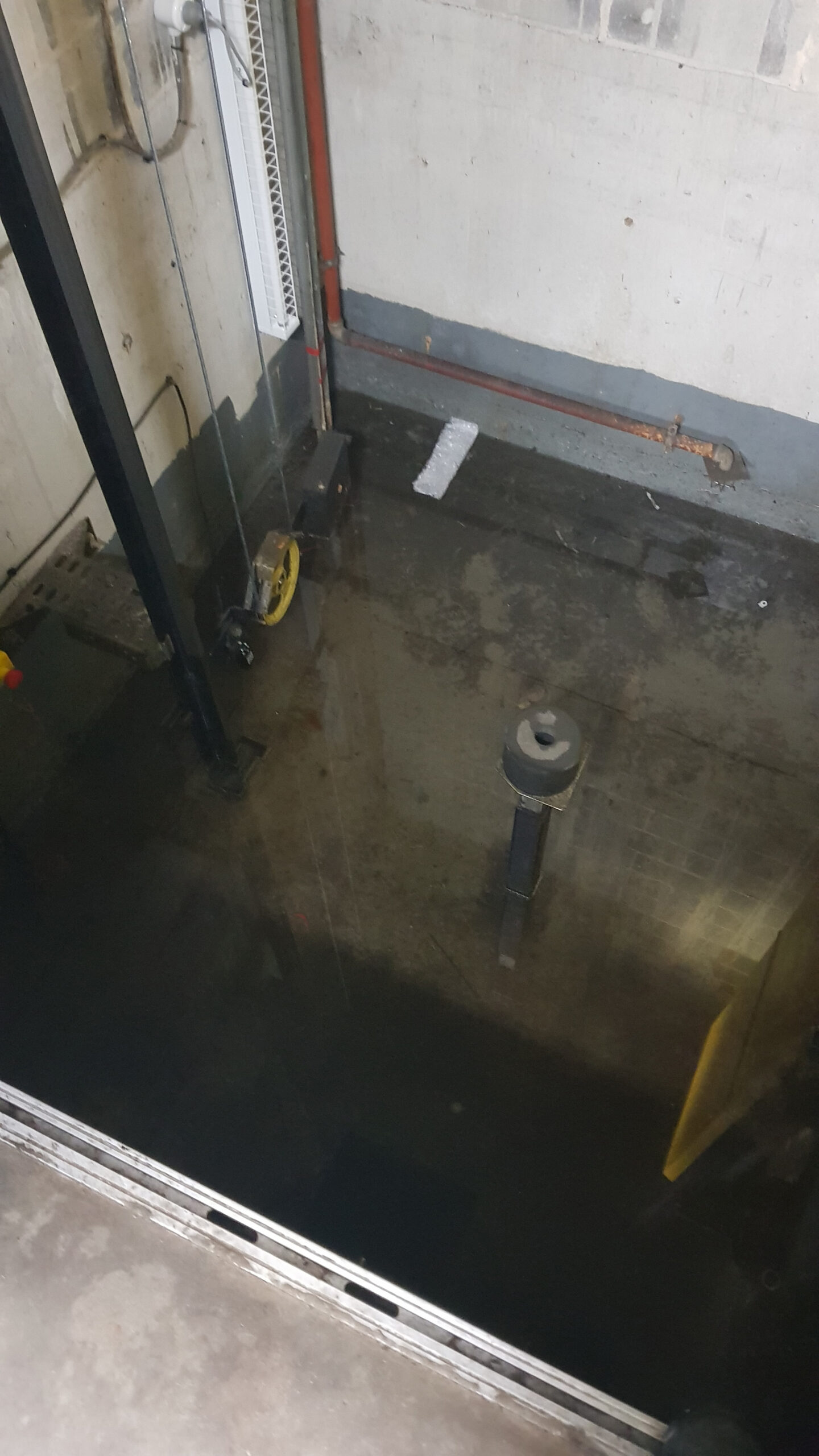 Elevator Pit flooded with water in car park post a huge April storm. We had to pump out and make dry for the elevator contractor to perform works and make repairs on the system. Water ingressed into the electrical system and the counnterweight pulley system. over $100,000 to repair.