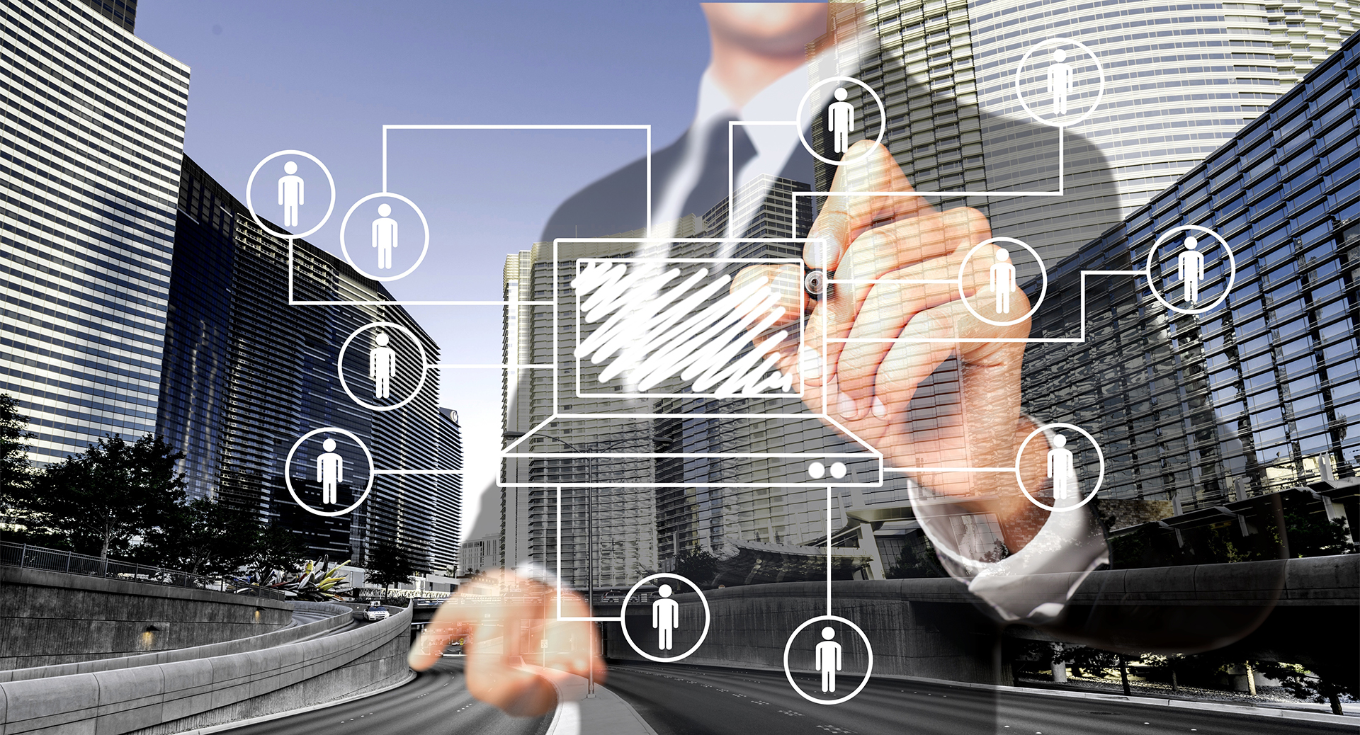 xecutive standing in front of four commercial city buildings, drawing a building diagram on a glass board with connected stakeholder icons, representing commercial property asset registers, building data management, and asset lifecycle planning.