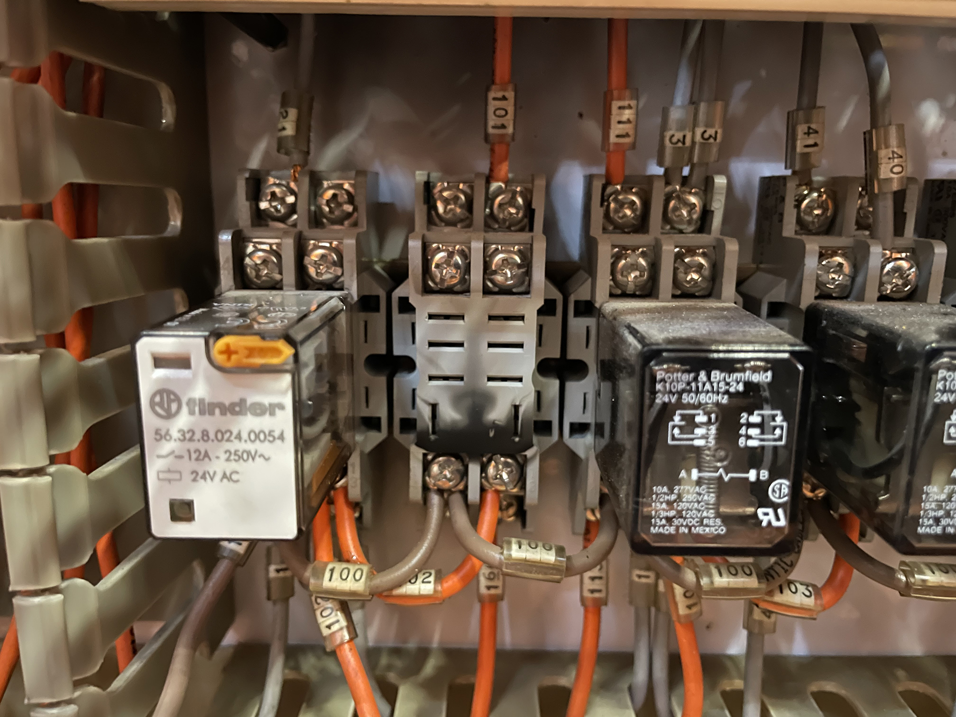 Burnt relay base within an essential services generator switchboard controlling HVAC emergency operation in a Sydney commercial building.