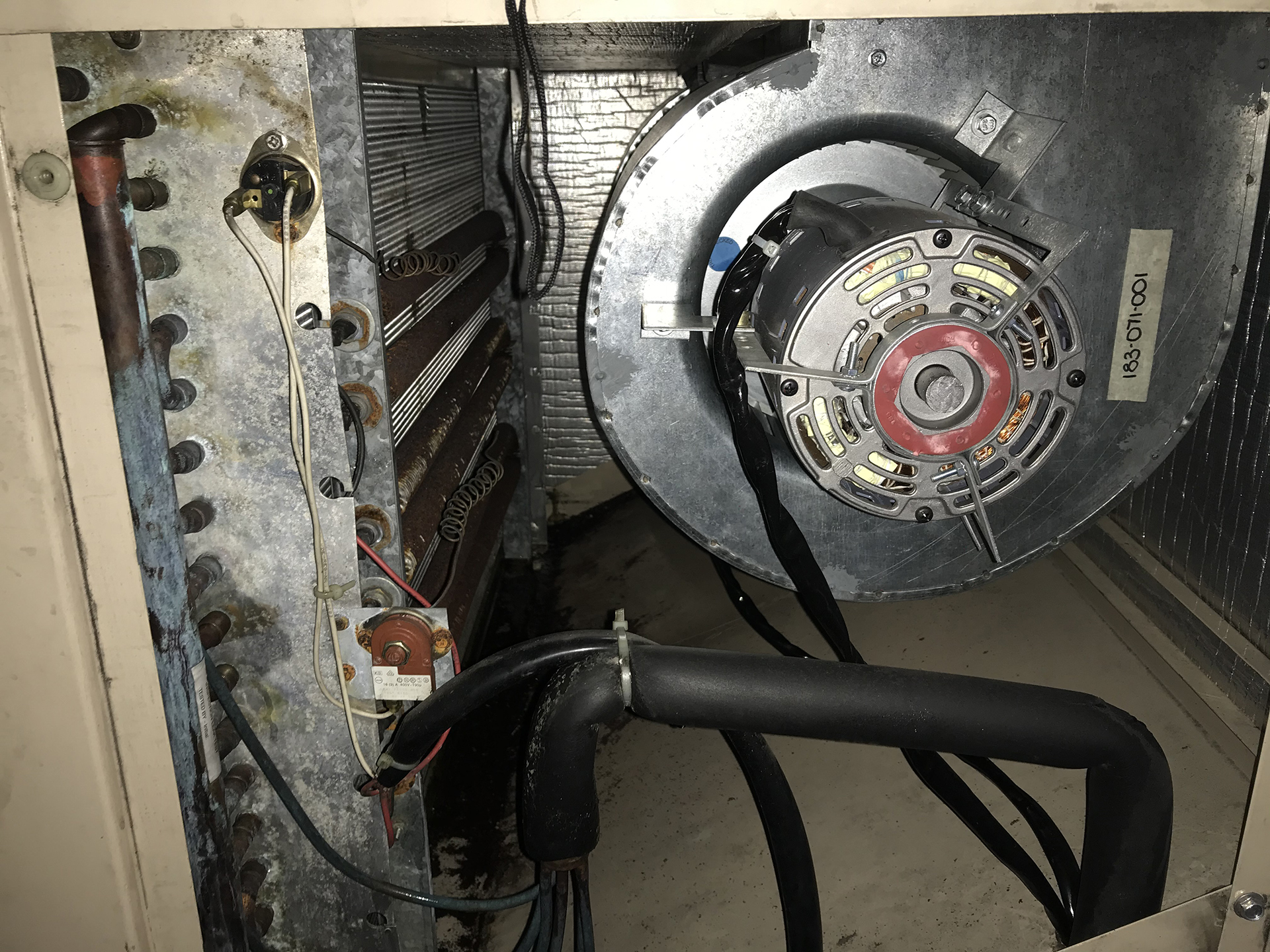 New fan coil unit showing EC fan assembly and cooling coil during a commercial HVAC replacement project.