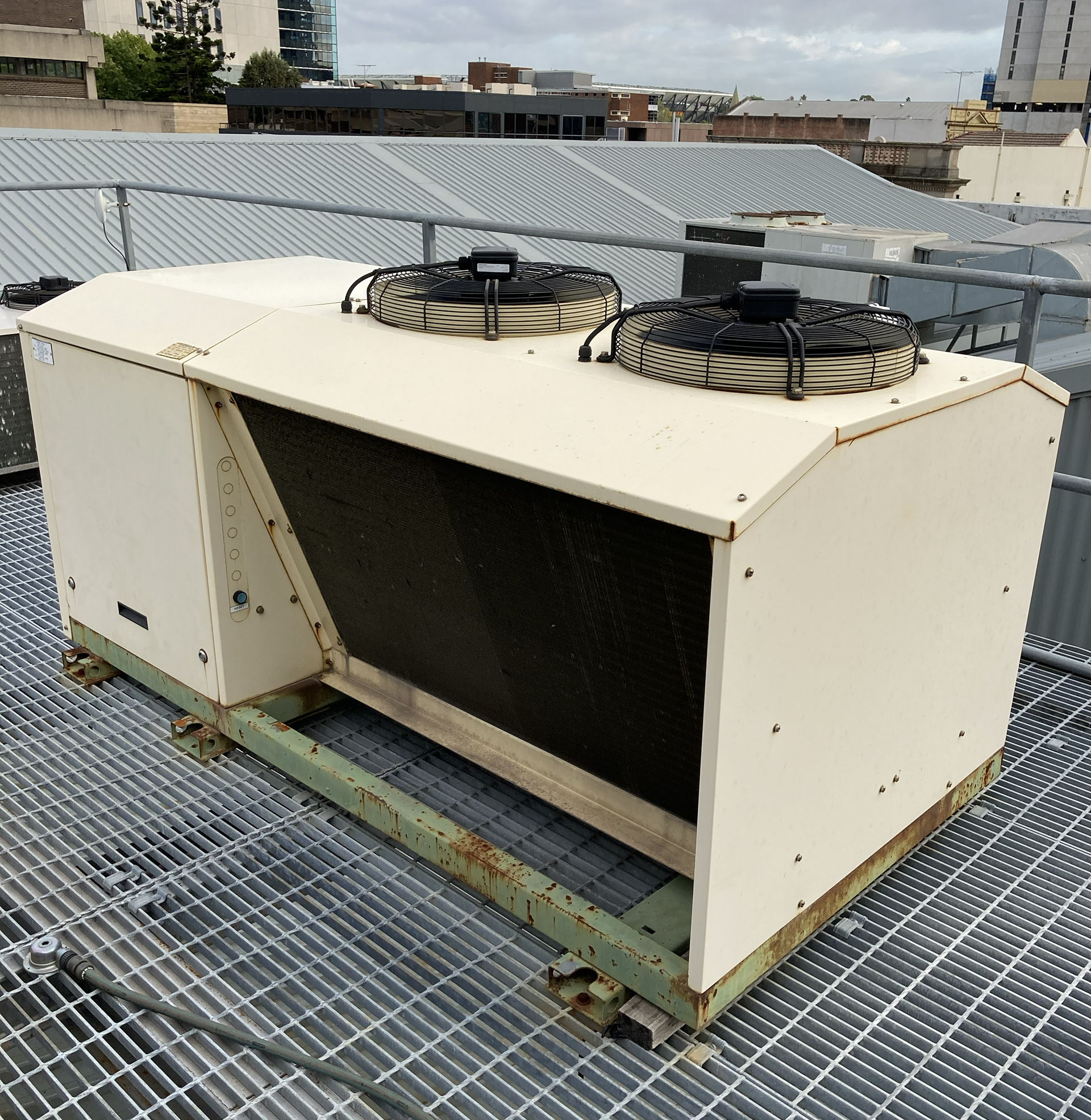 Commercial rooftop packaged air conditioning unit installed on a roof platform requiring preventative HVAC maintenance and inspection.
